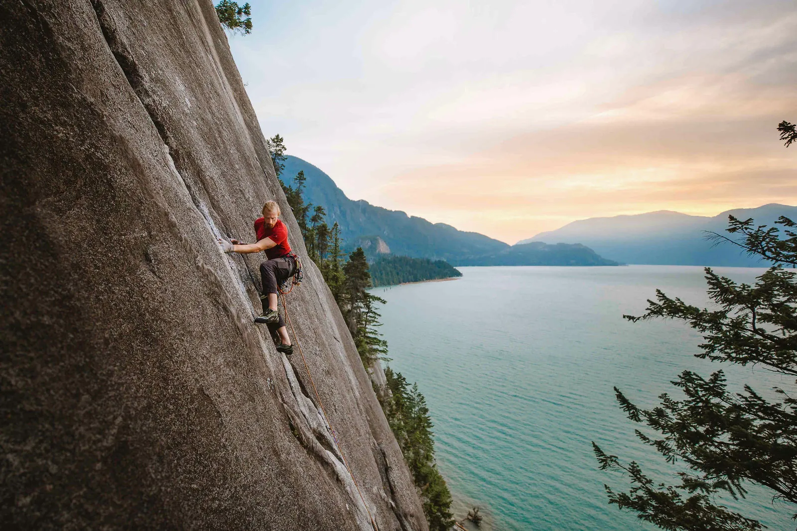 Trad climber placing gear on a Squamish granite route